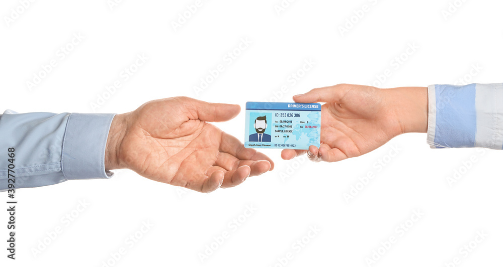 Male and female hands with driving license on white background