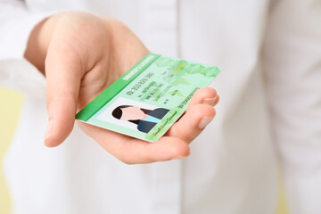 Wall Mural - Woman with driving license, closeup