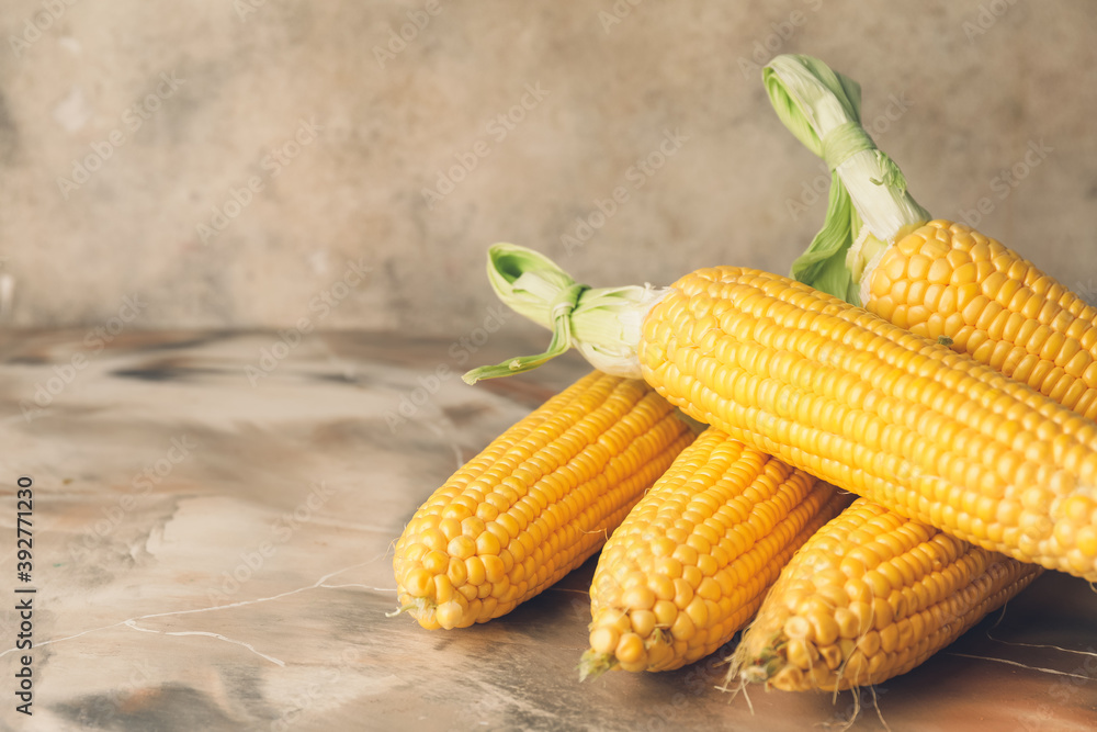 Fresh corn cobs on table