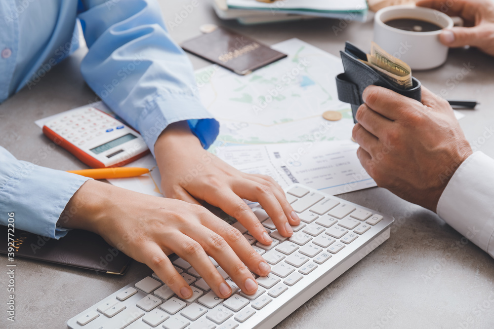 Travel agent choosing tour for client in office