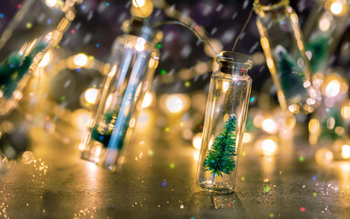 Wall Mural - snowy christmas tree in glass jar. decorative christmas lighting on glittery background