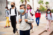 © JackF - Focused hispanic tweenager in medical face mask with backpack going to school lessons on warm autumn day. New lifestyle during coronavirus pandemic.