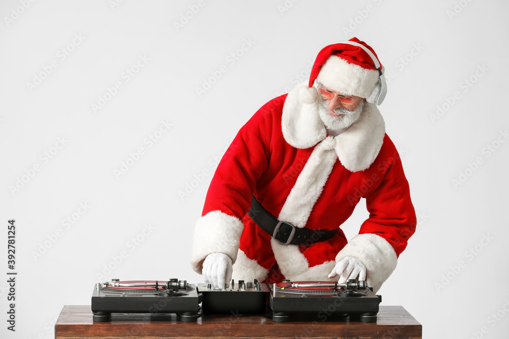 Cool Santa DJ playing music on grey background