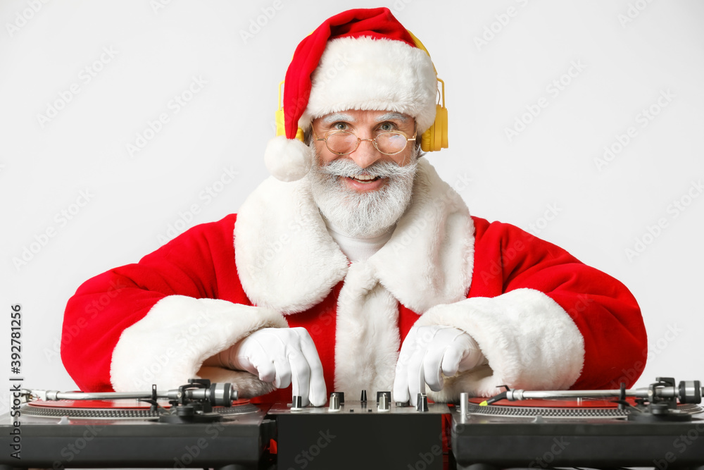 Cool Santa DJ playing music on grey background