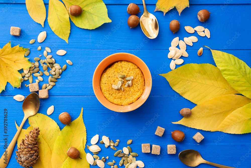 Autumn composition with tasty pumpkin pudding on color wooden background
