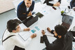 © xartproduction - top view Group of young business people working and communicating while sitting at the office desk together with colleagues sitting. business meeting