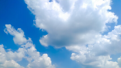 Huge cumulus clouds in blue sky flowing with wind