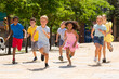 © JackF - Team of positive kids running in race in the street and laughing outdoors