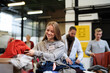© Halfpoint - Volunteers sorting out donated clothes in community charity donation center.