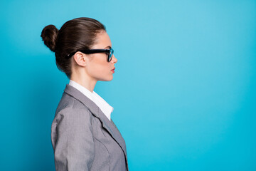 Poster - Close-up profile side view portrait of attractive content lady agent broker isolated over bright blue color background