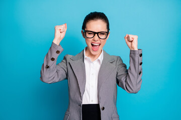 Poster - Portrait of attractive cheerful cheery lady coach rejoicing celebrating winning isolated over bright blue color background