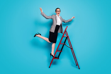 Sticker - Full size photo of positive girl agent stand ladder wear blazer jacket skirt stilettos isolated blue color background