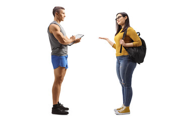 Poster - Full length profile shot of a fitness instructor and a female student having a conversation