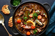 © lilechka75 - Beef bourguignon - meat stew with vegetables and mushrooms with red wine, traditinal dish of french cuisine. Top view with copy space.