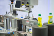 Sample products on bottle labeling machine in industrial machinery