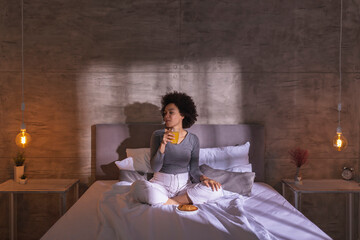 Woman eating breakfast in bed