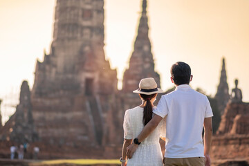 Couple Tourist wearing surgical face mask, protection COVID-19 pandemic during visiting in Wat Chaiwatthanaram temple in Ayutthaya. new normal, safety travel and Thailand travel concept