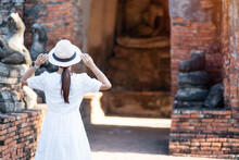 Tourist Woman In White Dress Visiting To Ancient Stupa In Wat Chaiwatthanaram Temple In Ayutthaya Historical Park, Summer, Asia And Thailand Travel Concept