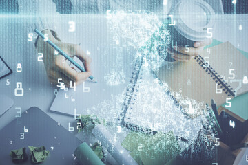 Double exposure of hands making notes background with technology and digital coding huds. Data learning concept.