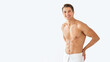 © Prostock-studio - Shirtless young man standing wrapped in towel at studio