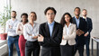 © Prostock-studio - Asian Businessman Posing Standing With His Employees Team In Office