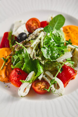 Roasted pepper salad with calamari and fresh greens