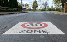 A 30km/h Speed Limit Traffic Road Sign Painted On The Road For A School Area In Germany