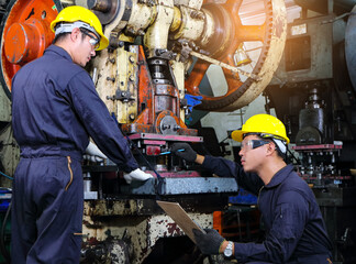 Asian male worker In industries that wear glasses, safety hats and safety uniforms Wrench tool holder stand