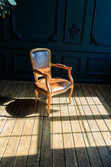 leather armchair on the wooden floor near the window