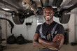 portrait of positive afro american auto mechanic in uniform posing after work, he is keen on repairing cars, automobiles.