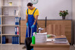 © Elnur - Young male contractor cleaning the office
