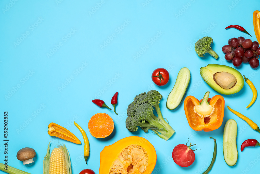 Flat lay composition with fresh organic fruits and vegetables on light blue background. Space for text - obrazy, fototapety, plakaty 