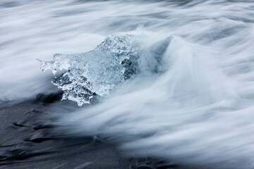 Wall Mural - icebergs in surf by jokulsarlon, iceland