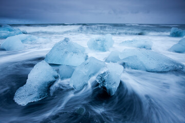 Wall Mural - icebergs in surf by jokulsarlon, iceland