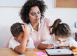 © Sabrina - Mother teach children at home with digital tablet - Home schooling - Focus on the woman