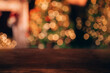 © Anastassiya  - Beautiful blurred Christmas background. In the foreground is a wooden table. In the background there is a Christmas tree and a fireplace