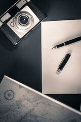 Business man desk, fountain pen, book, diary and photo camera.
Product photography black and gold fountain pen.