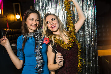 Portrait of happy young female friends together at nightclub