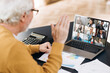 © Kateryna - Video conference. Business partners communicate via video conference using laptop. The old gray-hair man talks with his business partners and waving hand. Distant work