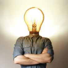 Concept Of A New Idea. A Man With A Light Bulb Instead Of A Head.