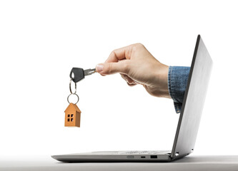 Key with paper house in human hand stick out of a laptop screen. Concept of modern technologies in real estate industry.