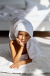 © jul14ka - Little girl wrapped in a towel relaxing in an expensive hotel room.