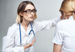© SHOTPRIME STUDIO - the nurse measures the temperature of the patient and the blue stethoscope