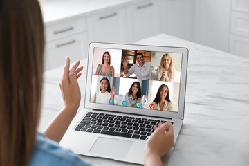 Wall Mural - Coworkers working together online. Woman using video chat on laptop, closeup