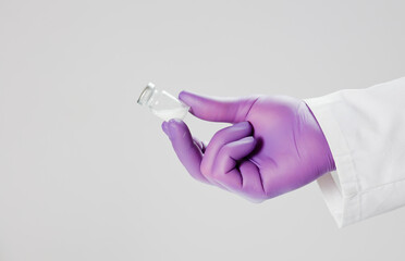 Wall Mural - Vaccine in hand of doctor with surgical gloves, white background.