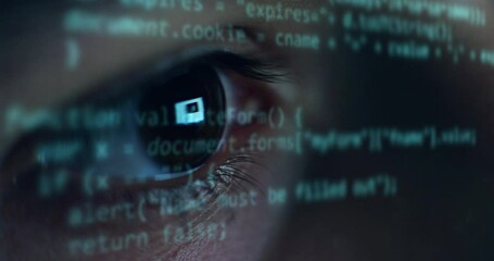 Cinematic macro of young programer's eye while busy working with latest innovative sophisticated technology display application with augmented reality holograms for realization of new codeproject.