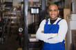© JackF - Skilled hispanic worker of building materials warehouse posing near racks with goods