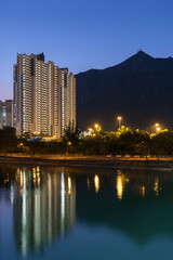 Wall Mural - High rise residential building and mountain in Hong Kong city at dusk