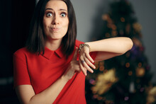 Woman Checking The Time Being Late For Christmas Party