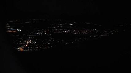 Wall Mural - night city landscape from an airplane window, travel and tourism concept